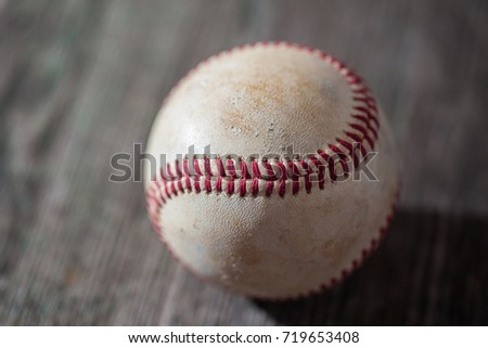 A baseball on an old wood table, sport.