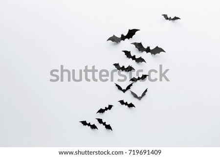 halloween and decoration concept - black paper bats flying over white background Royalty-Free Stock Photo #719691409