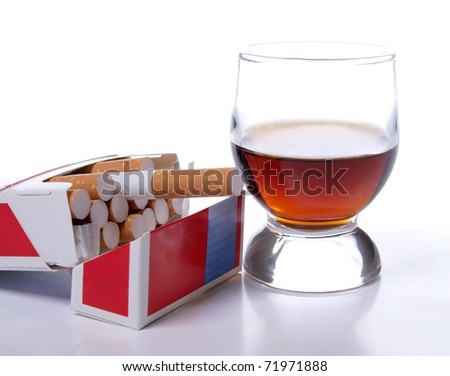 Color photo of a glass of whiskey and a pack of cigarettes Royalty-Free Stock Photo #71971888
