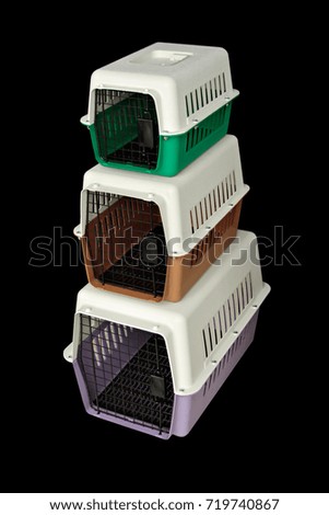 Pet carrier or portable cage for moving or traveling anywhere and transportation. Lay a vertical arrangement on a black background.