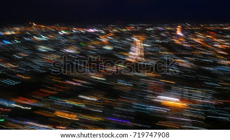 The blur of light as the plane goes up. abstract blur bokeh of night light city look from airplane. (Blurred effect form camera)
