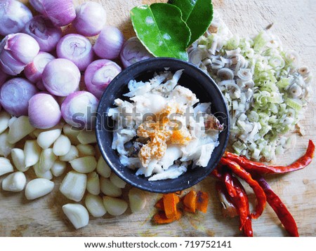 Top view picture of preparing Thai curry crab consist of shallot, garlic, dried chili, turmeric, lemon grass, kaffir lime leaf and meat crab.