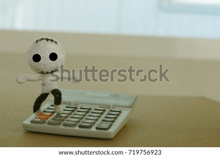 Voodoo doll and calculator