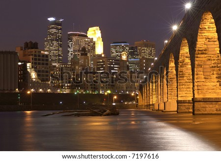 Minneapolis skyline at dusk with the Mississippi river and the Stone Arch Bridge