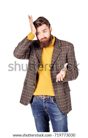 Forgetful young man gesturing with surprise. emotions, facial expressions, feelings, body language, signs. image on a white studio background.
