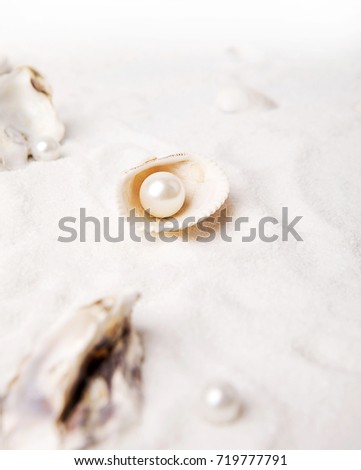 White pearls are in the sand