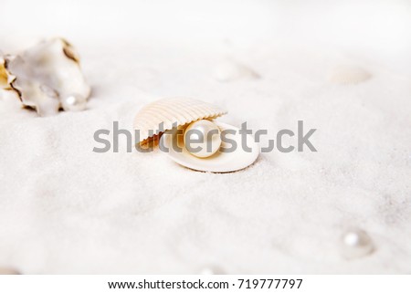 White pearls are in the sand