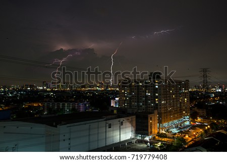 Lightning storm over the city at night