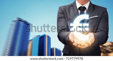 Businessman hold euro currency symbol and modern city : Business economic financial concept