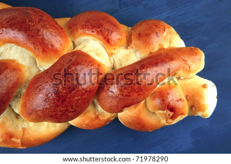 sweet bread : golden challah over blue wooden plate