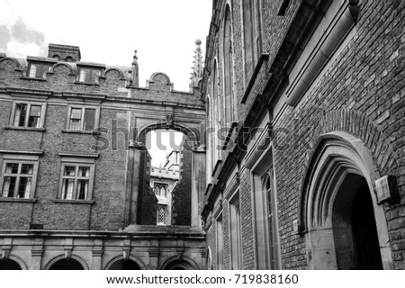 Cambridge (UK). Architectural detail. View from the street through aperture to the inner court. Black and white photo.
