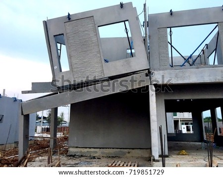 Damaged home construction,architecture detail of damaged house corner dilapidated Construction is not standard  over blue sky background. Unfinished private residences. Royalty-Free Stock Photo #719851729