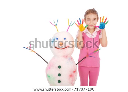 Beautiful girl with hands in paint near color snowman with colored horns and hands. On white background.