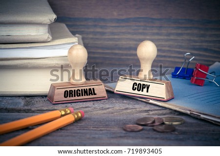Original and Copy concept. Rubber Stamp on desk in the Office. Business and work background Royalty-Free Stock Photo #719893405