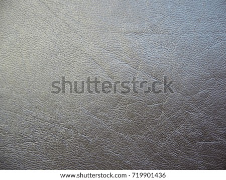 Texture of natural leather. Dark background. Brown leather.