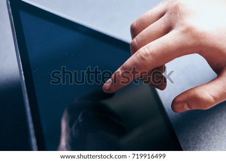 touching the tablet screen close-up, business                               