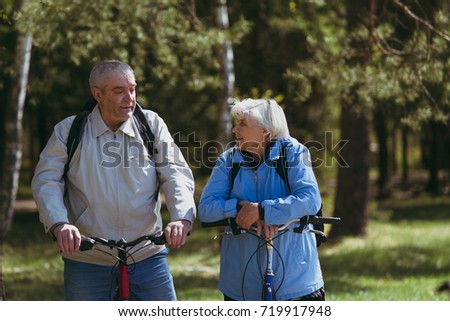 Senior couple riding bikes in nature