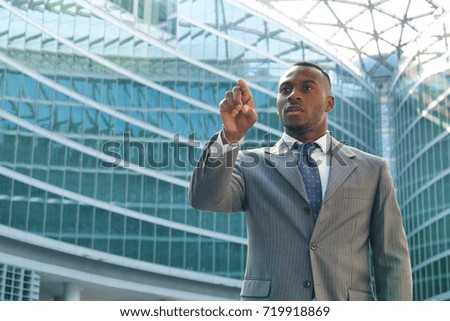 A businessman touches with your finger in front of him for business and futuristic graphic implementations. Concept of: future, augmented reality, business.