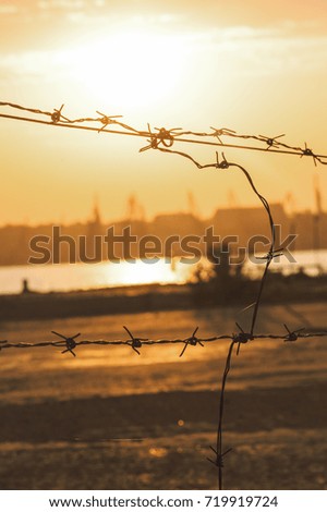 Forbidden territory with barbed wire at the sunset,sunrise with the sun.