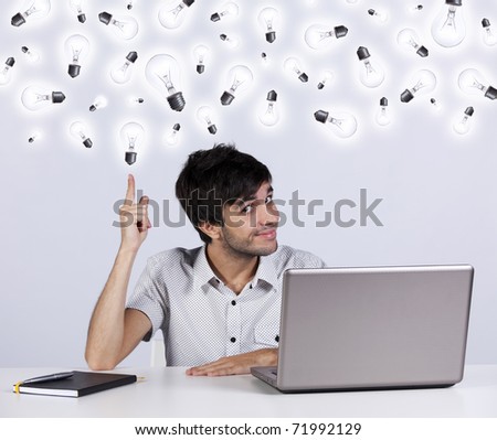 Young man with lots of ideas in the office working with his laptop Royalty-Free Stock Photo #71992129