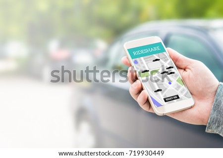 Rideshare taxi app on smartphone screen. Online ride sharing and carpool mobile application. Modern people and commuter transportation service. Man holding phone with a car in background. Royalty-Free Stock Photo #719930449