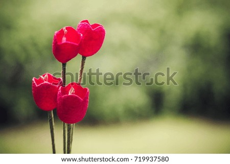 Red artificial flowers. Vintage color tone.