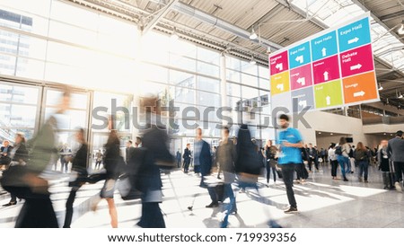 Large crowd of business people walking at a trade fair