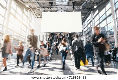 crowd of anonymous blurred business people at a trade fair 