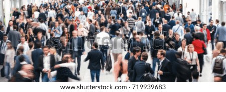Anonymous crowd of people walking in a hall