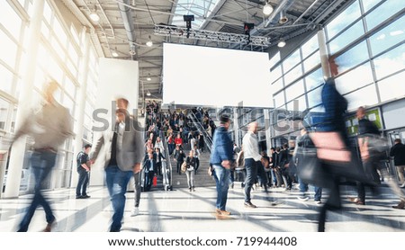 anonymous blurred people at a trade fair 