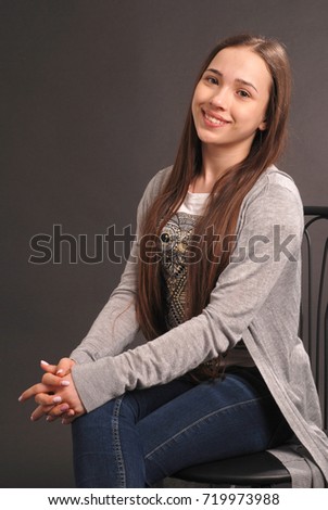 Portrait of gorgeous young girl over black background