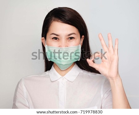 Asian women Wear protective masks.Make a gesture OK. Conception about healthcare