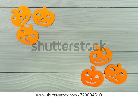 Top view of paper silhouette of six different pumpkin made of vertical frame on grey wooden background. Halloween holiday background. Copy space