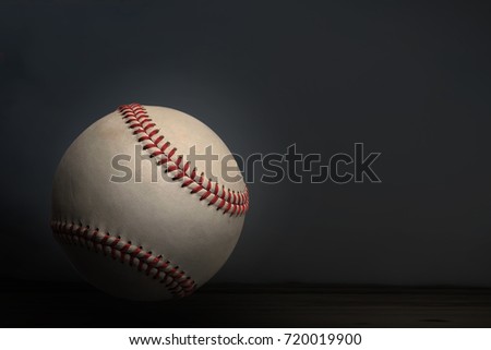 Vintage baseball ball in dark light background.