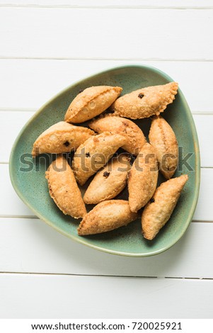 Stock Photo of Karnaji or gujia is a sweet dumpling made from maida and stuffed with khoya . It is common sweet in north India and these are usually on diwali or festival time, selective focus
