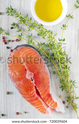 freshly cut raw salmon with spices on wooden surface