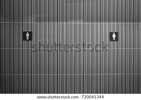 wall in front of toilet with sign or symbol of Man and Women