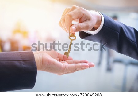 Man giving women a  golden key to success