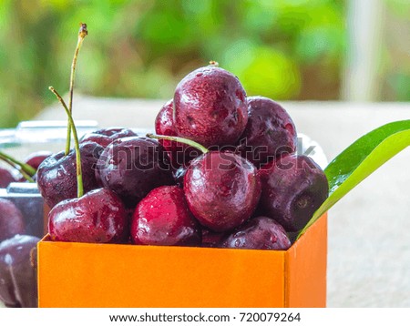 Cherry in an orange present box.