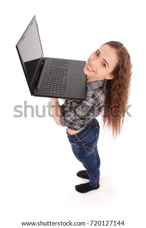 Young girl standing and using a laptop, isolated on white