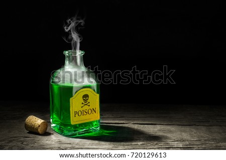The poison is a green liquid in a glass vial. A deadly potion with a skull and bones on the label. Copy space for text. 3D rendering Royalty-Free Stock Photo #720129613