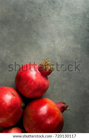 Ripe Red Vibrant Organic Pomegranates on Black Stone Background Poster Greeting Card Template Banner Autumn Fall Thanksgiving Rosh Hashanah Copy Space