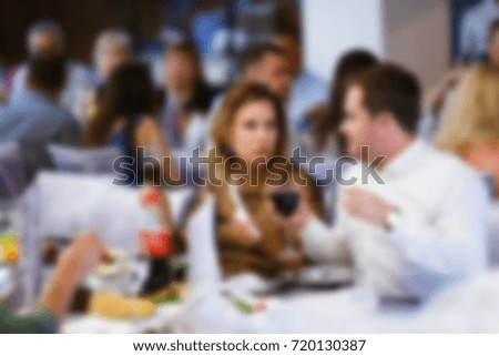 Blur people eating and talking in dining room, restaurant party celebration concept