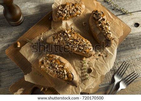 Homemade Twice Baked Sweet Potatoes with Butter Pecans and Herbs Royalty-Free Stock Photo #720170500