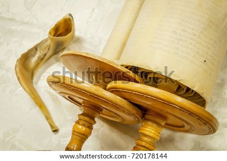 Torah scrolls and a "shofar" musical horn, both used in the Judaism religious services in a synagogue. Sefer Torah 
book megillah Judaism prayer. Tisha beav, yom kippur, Tisha B'Av Royalty-Free Stock Photo #720178144
