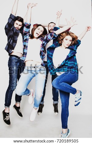 emotional, happiness and people concept: Two happy couples in casual clothing jumping in the air rejoicing with their arms raised isolated on white.Special Fashionable toning photos.