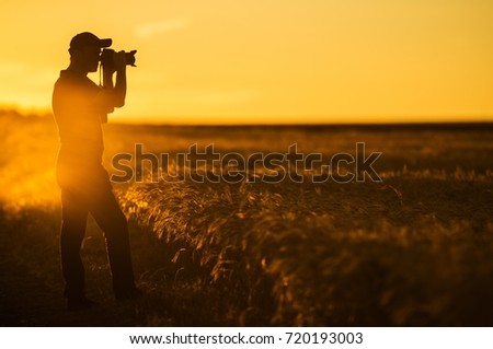 Photographer and the Nature. Men in His 50s Taking Pictures of Scenic Countryside Landscape During Golden Hour.