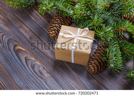 gifts boxes with fir branches on wooden background top view.