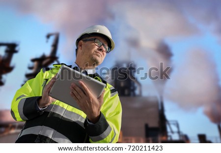 Construction engineer against Polluting factory at dawn