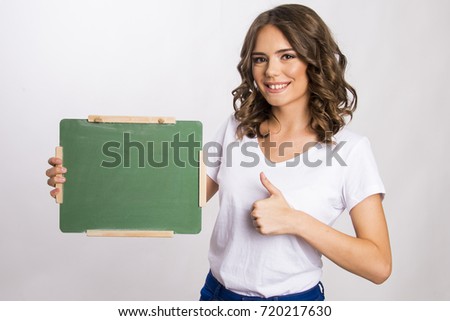 Girl holding a little green board